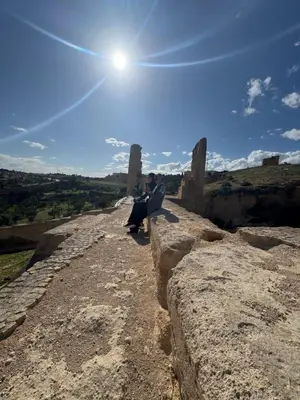 a person sitting on the edge of a hill at Riad zineb in Fès