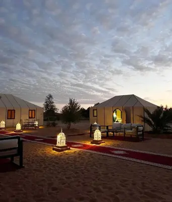 two luxury tents in the desert at sunset at Nada luxury desert camp in Merzouga