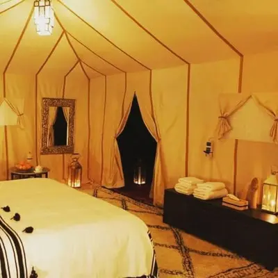 a bedroom with a bed in a tent at Nada luxury desert camp in Merzouga