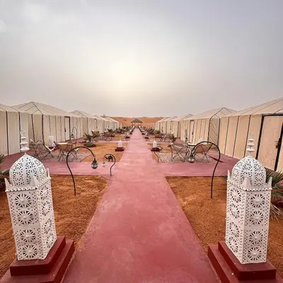 a row of rows of tents in the desert at Nada luxury desert camp in Merzouga