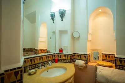 a bathroom with a sink and a mirror at Villa luxe ADAMA avec gouvernante- Marrakech in Marrakech