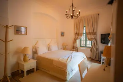 a bedroom with a bed and a chandelier at Villa luxe ADAMA avec gouvernante- Marrakech in Marrakech