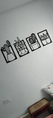 a wall with black and white pictures on it at Petit appartement in Meknès