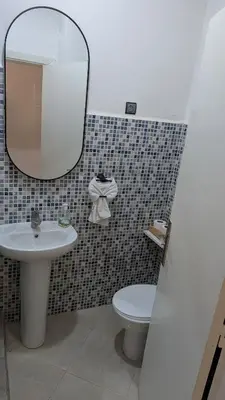 a bathroom with a sink and a toilet and a mirror at Apartment 2-Bedroom 20 minutes from downtown in Oulad Akkou