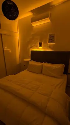 a bedroom with a large white bed in a room at Apartment 2-Bedroom 20 minutes from downtown in Oulad Akkou