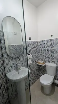 a bathroom with a toilet and a sink and a mirror at Apartment 2-Bedroom 20 minutes from downtown in Oulad Akkou