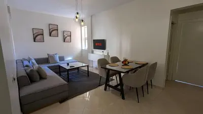 a living room with a couch and a table at Apartment 2-Bedroom 20 minutes from downtown in Oulad Akkou