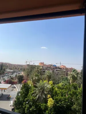 a view of a city from a window at Duplex de rêve en face du jardin majorelle in Oulad Akkou