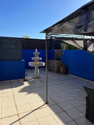 a fountain sitting under a tent on a patio at Duplex de rêve en face du jardin majorelle in Oulad Akkou
