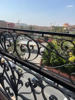 a view of a city from a balcony at Duplex de rêve en face du jardin majorelle in Oulad Akkou