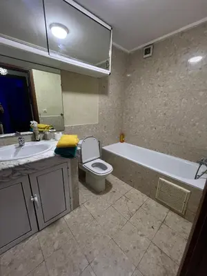 a bathroom with a tub and a toilet and a sink at Duplex de rêve en face du jardin majorelle in Oulad Akkou