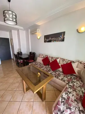 a living room with a couch and a table at منزل لزعر in Moulay Yacoub