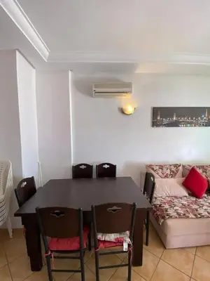 a dining room with a table and chairs and a couch at منزل لزعر in Moulay Yacoub