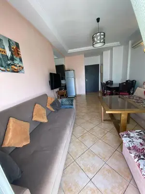 a living room with a couch and a table at منزل لزعر in Moulay Yacoub