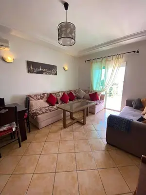 a living room with a couch and a table at منزل لزعر in Moulay Yacoub