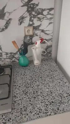 a room with a bed with a table with a cow blender at Les jardins de temara in Oulad Akkou