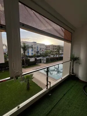 a room with a large window with a view of a pool at Dyar lbahr in Oulad Akkou