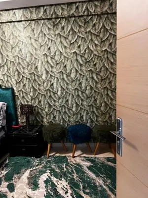 a room with two chairs in front of a wall at Dyar lbahr in Oulad Akkou