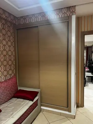 a bed with a sliding door in a room at Dyar lbahr in Oulad Akkou