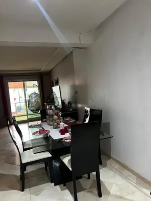 a dining room with a black table and chairs at Dyar lbahr in Oulad Akkou