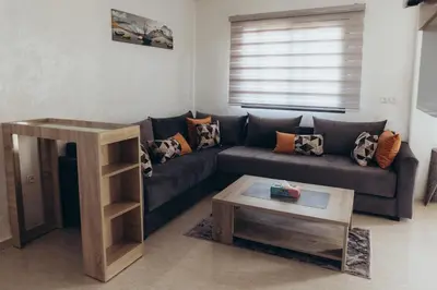 a living room with a couch and a coffee table at Villa La Rêverie in Ain Cheggag