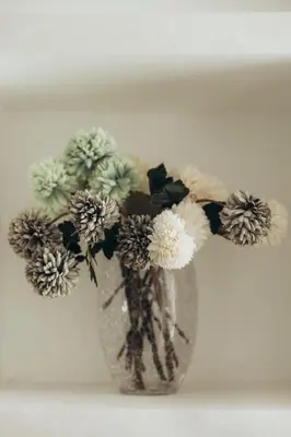 a vase filled with flowers sitting on a table at Villa La Rêverie in Ain Cheggag