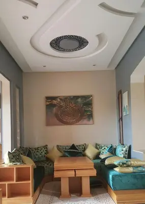 a living room with a couch and a table at Beautiful Moroccan-style villa in Douar Soukkane