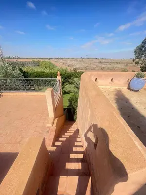 a set of stairs leading up to a building at Beautiful Moroccan-style villa in Douar Soukkane
