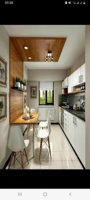 a kitchen with a wooden table and white chairs at Appart bien meublé pour location in Oulad Akkou