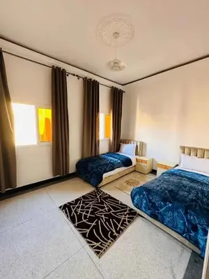 a bedroom with two beds and a window at Appart bien meublé pour location in Oulad Akkou