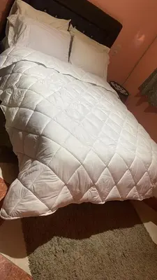 a white bed with white sheets and pillows at Résidence Kawtar Meknès in Meknès
