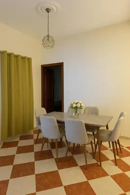 a dining room with a table and chairs at Résidence Kawtar Meknès in Meknès