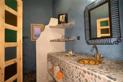a bathroom with a counter with a sink and a mirror at Casa Juan in Tagounite