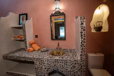 a bathroom with a table with a sink and a mirror at Casa Juan in Tagounite