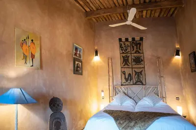 a bedroom with a bed and a ceiling fan at Casa Juan in Tagounite