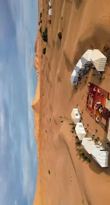 an aerial view of a beach on a sand dune at Merzouga LUXURY TENT in Merzouga
