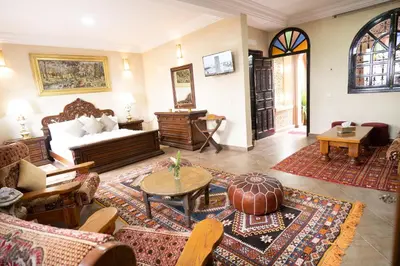 a living room with a couch and a table at Riad Rayhana De L Atlas in Ourika