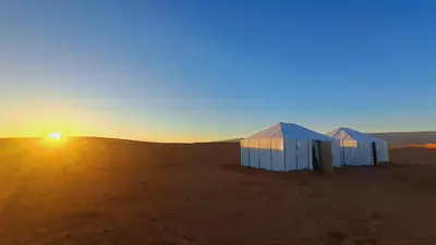 two white tents in the desert at sunset at Bivouac Le secret des dunes, lac Iriqui in Foum Zguid