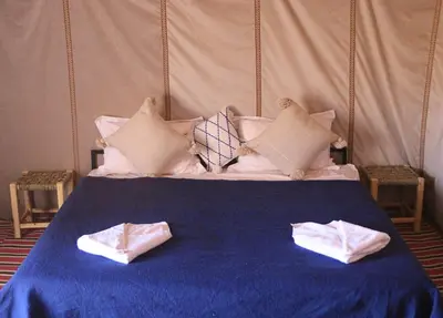 a bed with two towels on top of it at Bivouac Le secret des dunes, lac Iriqui in Foum Zguid