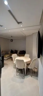 a room with a table and chairs and a couch at إقامة جنان كاميليا مكناس in Douar Sidi Cherki