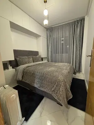 a bedroom with a large bed and a window at إقامة جنان كاميليا مكناس in Douar Sidi Cherki