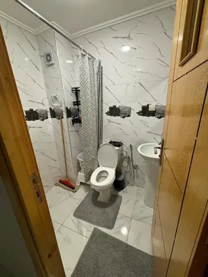 a bathroom with a toilet and a sink at إقامة جنان كاميليا مكناس in Douar Sidi Cherki