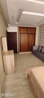 a large room with a bed and a couch at Sublime appartement front de mer in Oulad Akkou