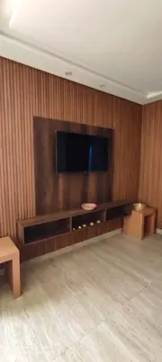 a living room with a flat screen tv on a wall at Sublime appartement front de mer in Oulad Akkou