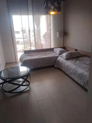 a bedroom with a bed and a glass table at Bir jdid in Oulad Akkou