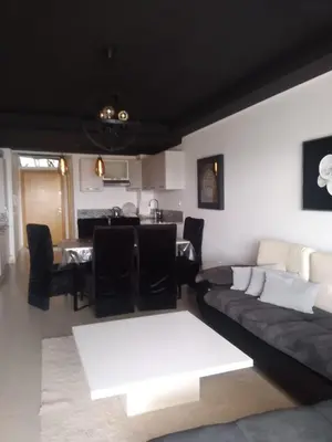 a living room with a couch and a table at Bir jdid in Oulad Akkou