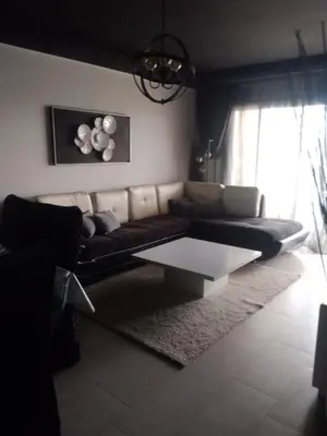 a living room with a couch and a coffee table at Bir jdid in Oulad Akkou
