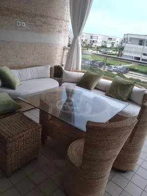 a living room with a couch and a table and chairs at Bir jdid in Oulad Akkou
