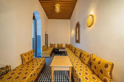 a waiting room with couches and a table in a building at Riad Old City Palace in Fès
