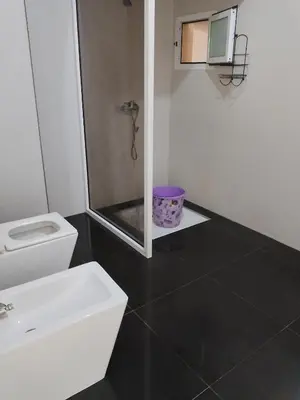 a bathroom with a toilet and a sink at إقامة المنظر الجميل in Oulad Akkou